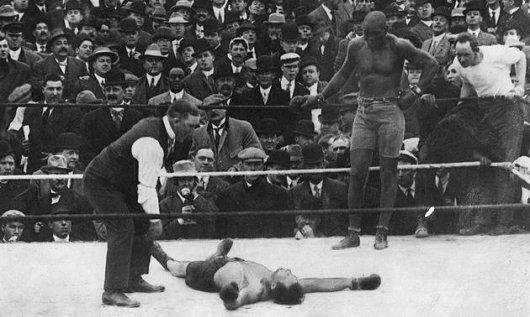 African American boxer Jack Johnson whooping some white dude.