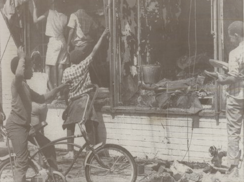 On June 27, 1969, these kids were pictured going through one of the burned out businesses along North 24th Street after the killing of Vivian Strong.